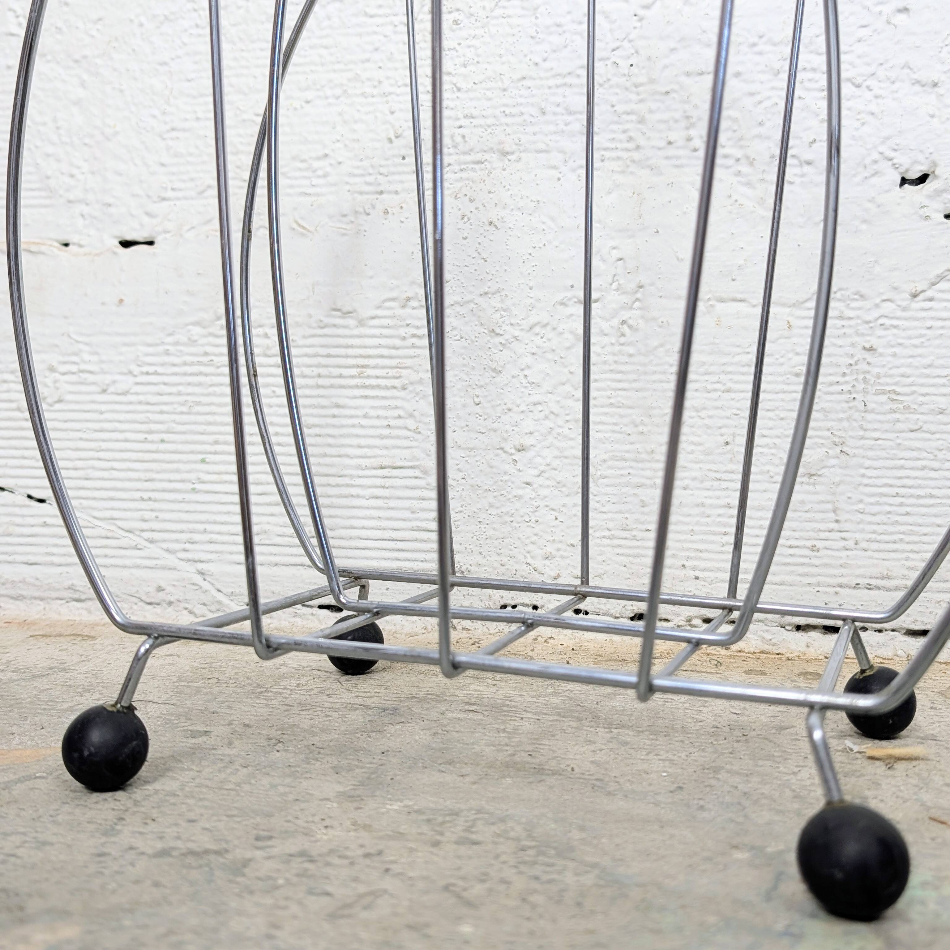 Vintage chrome magazine rack with ball feet