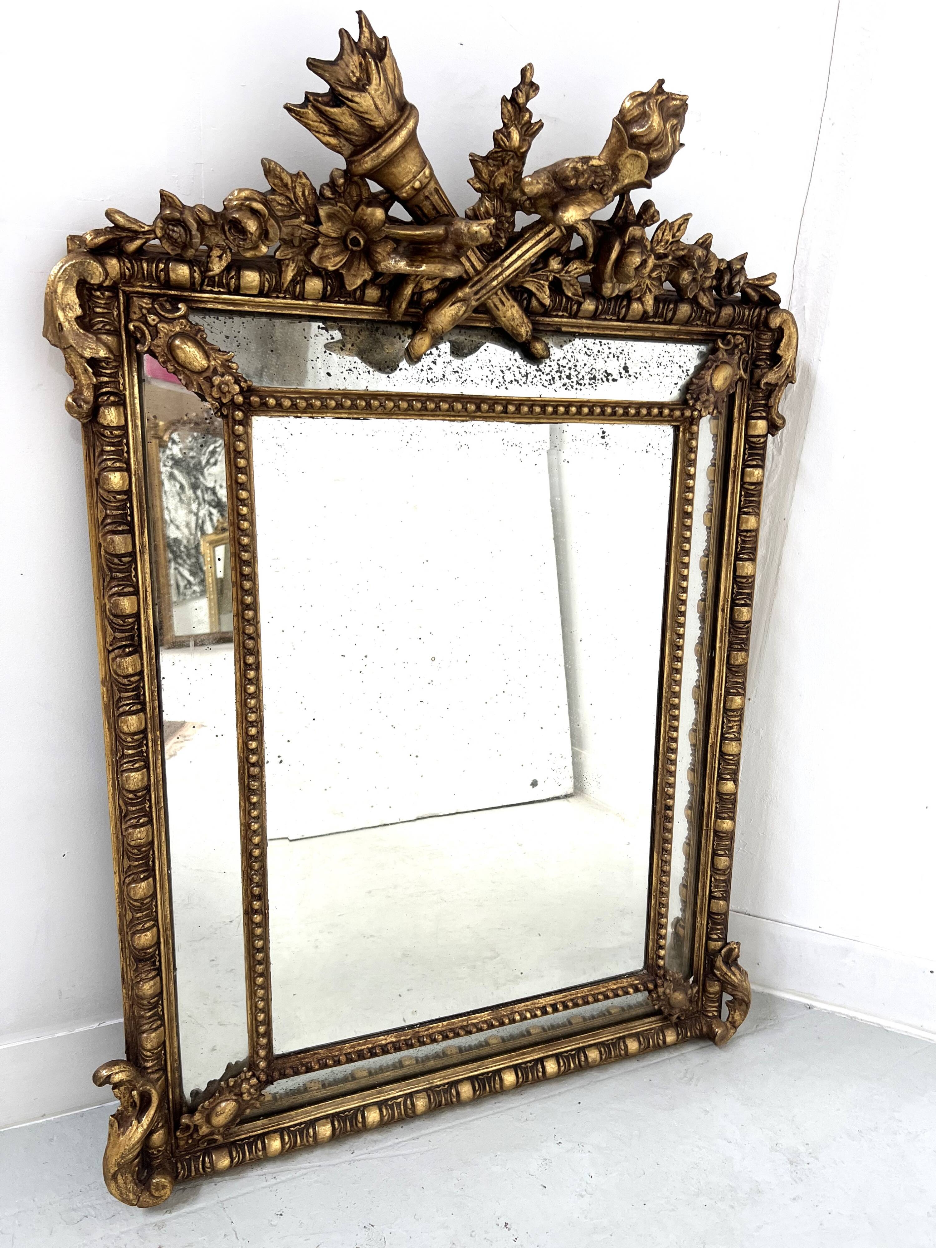 Louis XVI style mirror with parecloses in wood and gilded stucco, 19th century