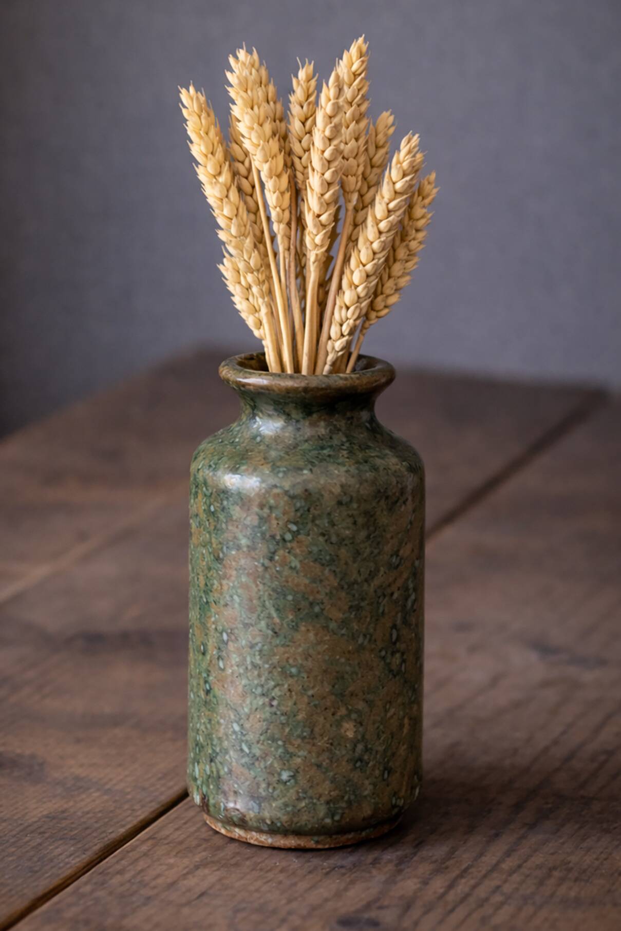Wabi-sabi artisanal stoneware vase in green and earth tones.
