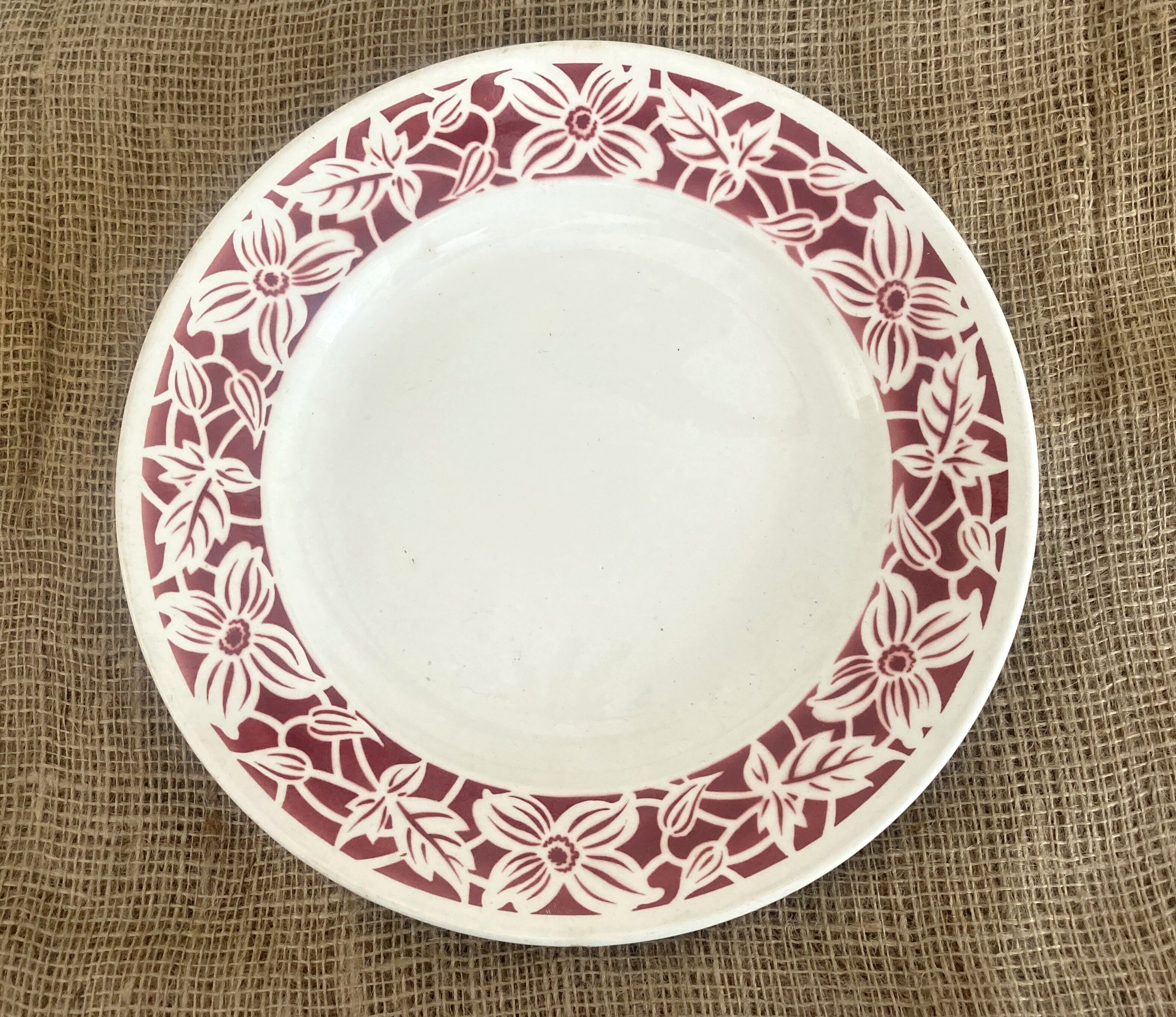 Round serving dish with burgundy red floral pattern