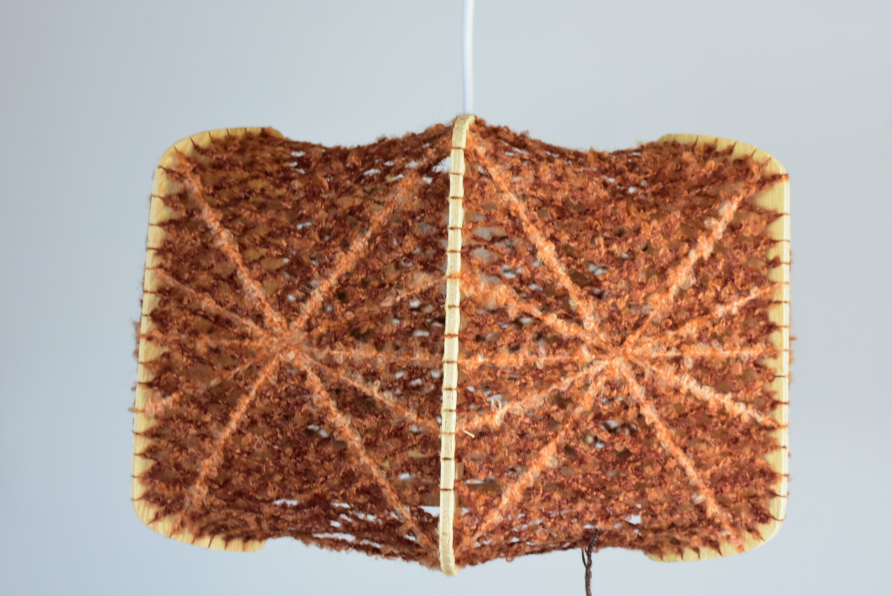 Brown wire and wood pendant light.