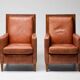 Pair of Art Deco armchairs in brown leather and teak, Netherlands, 1970s.