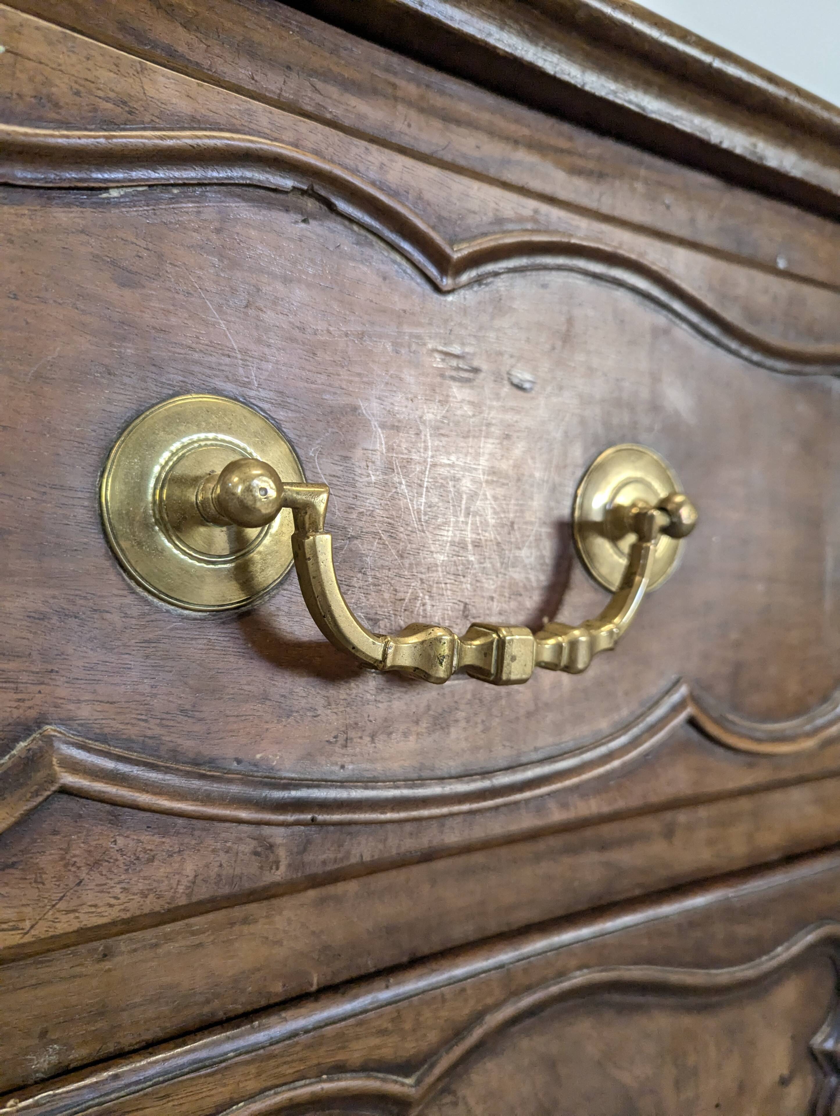 18th century Lyonnaise chest of drawers in carved walnut and bronze