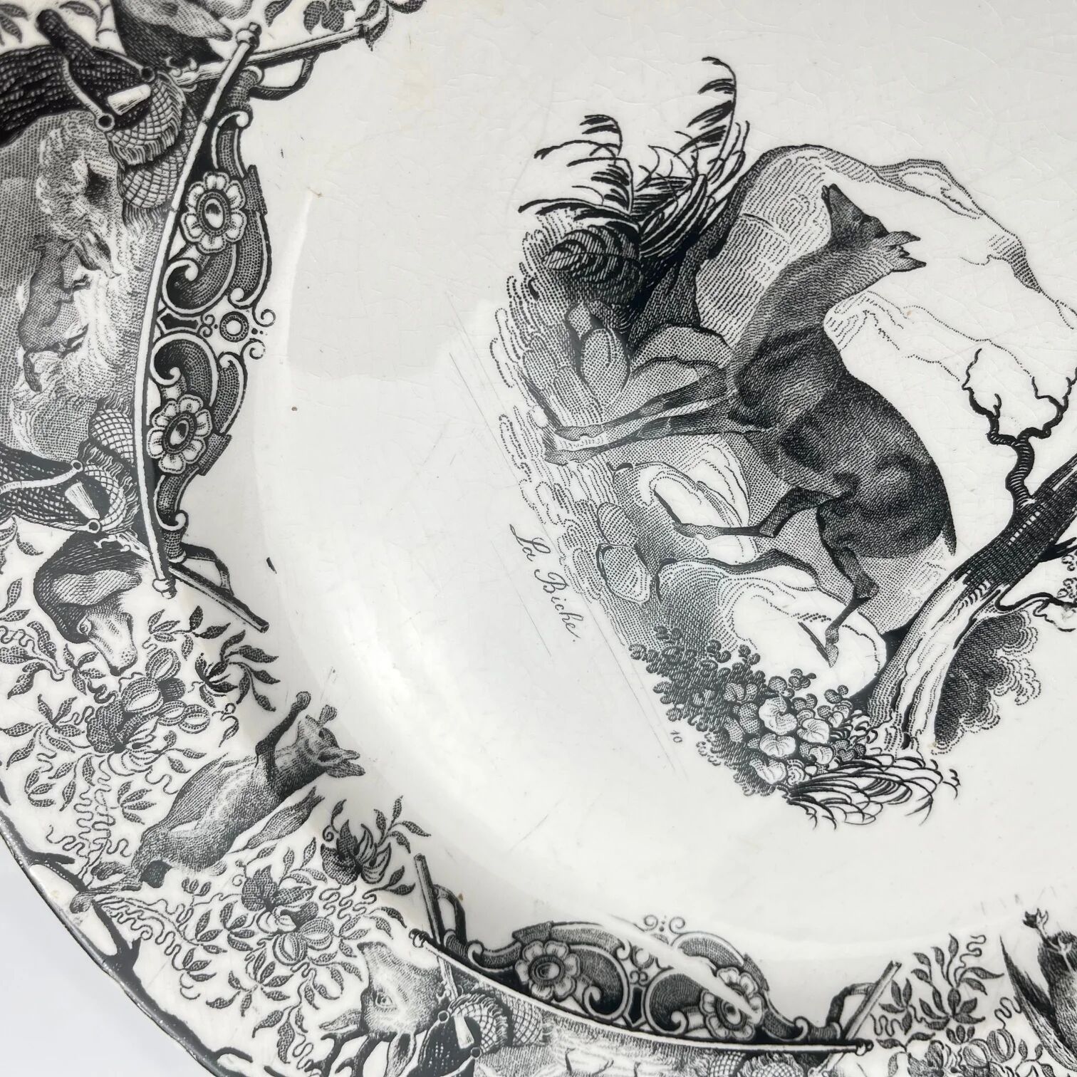 Set of three antique Sarreguemines U&C plates with hunting decoration from 1850 - 19th century black earthenware featuring a doe, chamois, and fox.