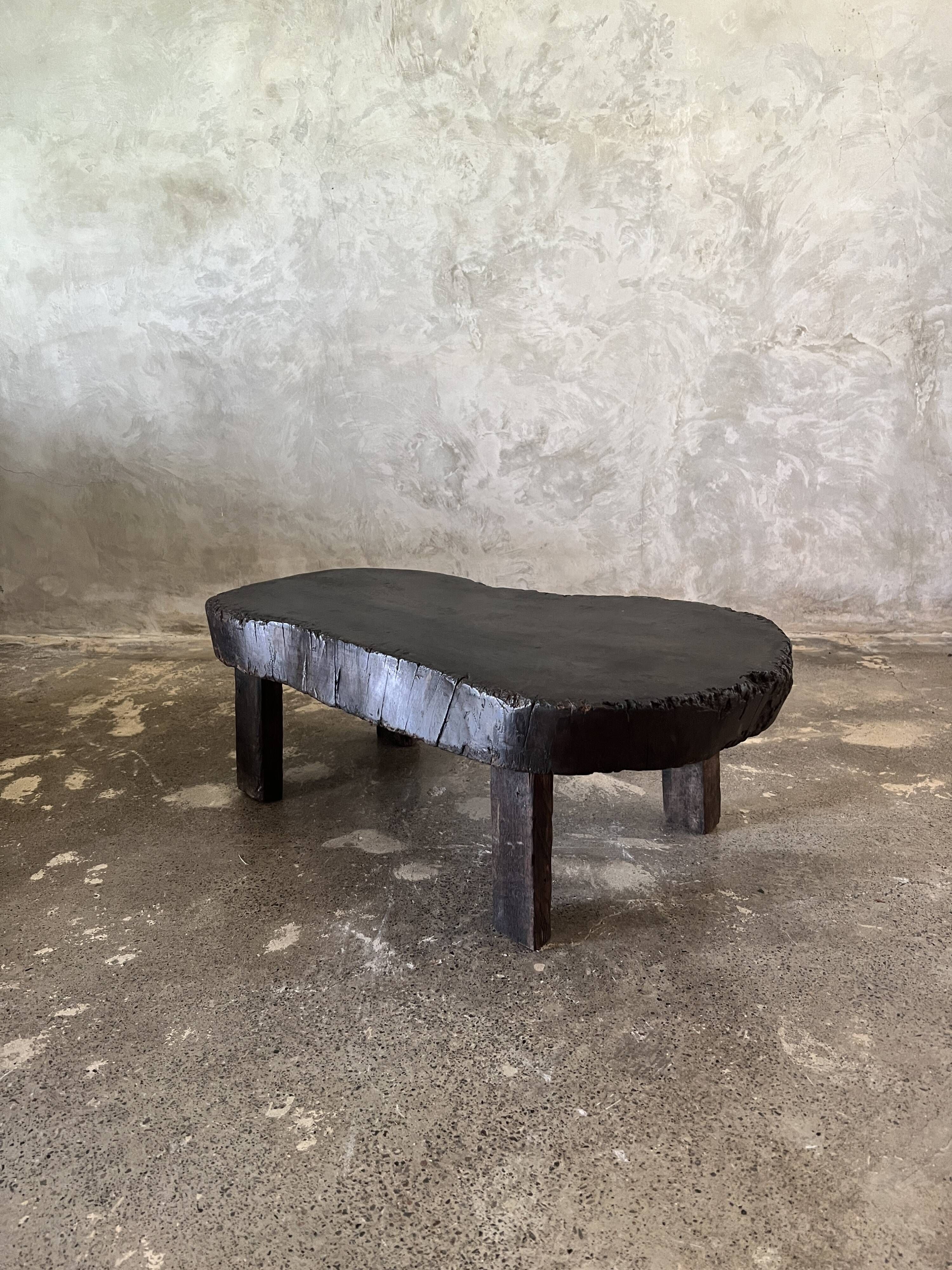 Small old Asian wooden coffee table in Japanese style, kidney-shaped top