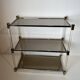 Lucite Shelf with Three Smoked Glass Shelves and Brass Ends. Work