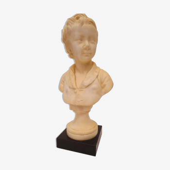 old bust of a young child in ivory marble on black marble base