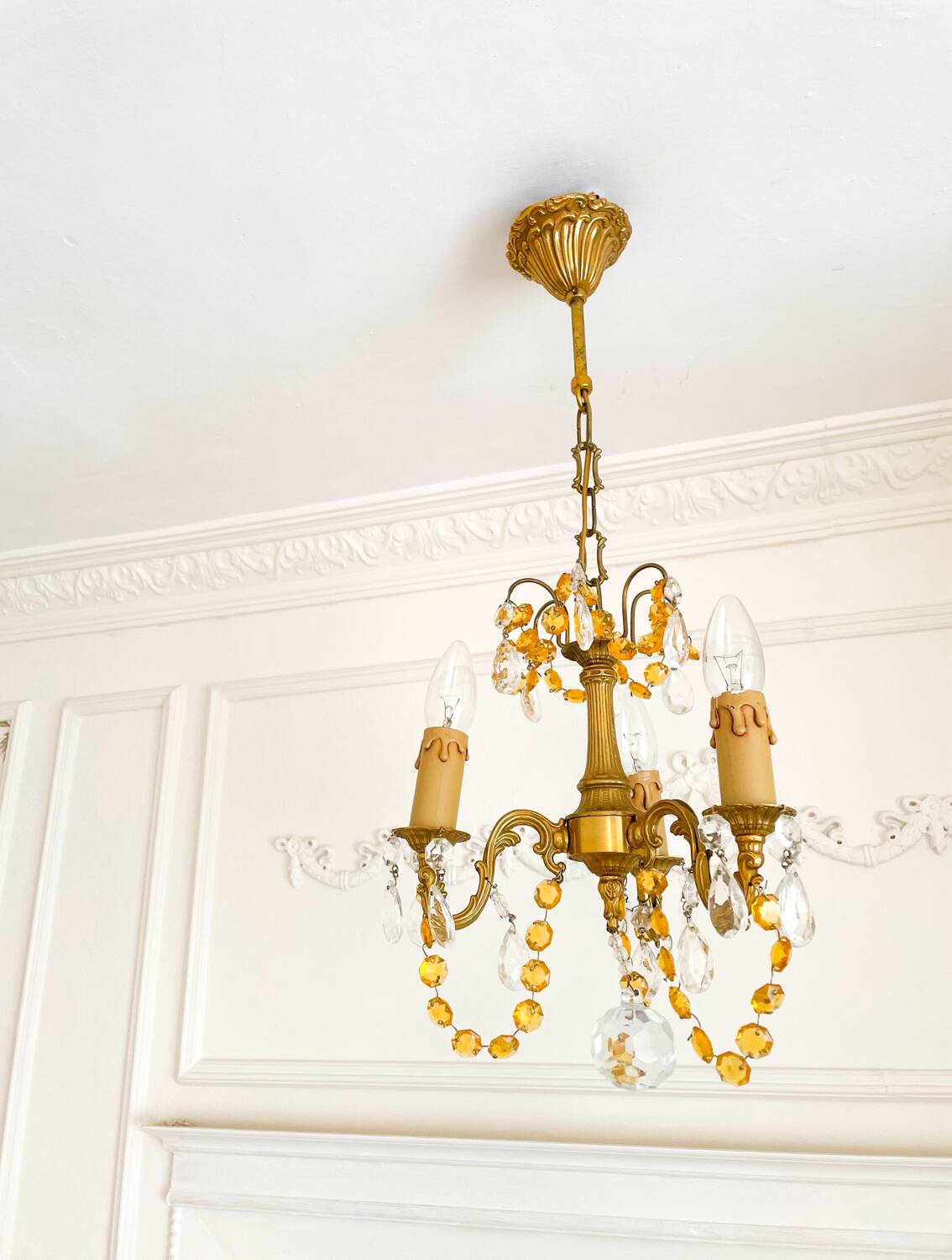 Small vintage brass chandelier with amber crystal pendants.