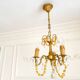 Small vintage brass chandelier with amber crystal pendants.