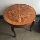 Round marquetry coffee table with curved legs in Louis XV style.
