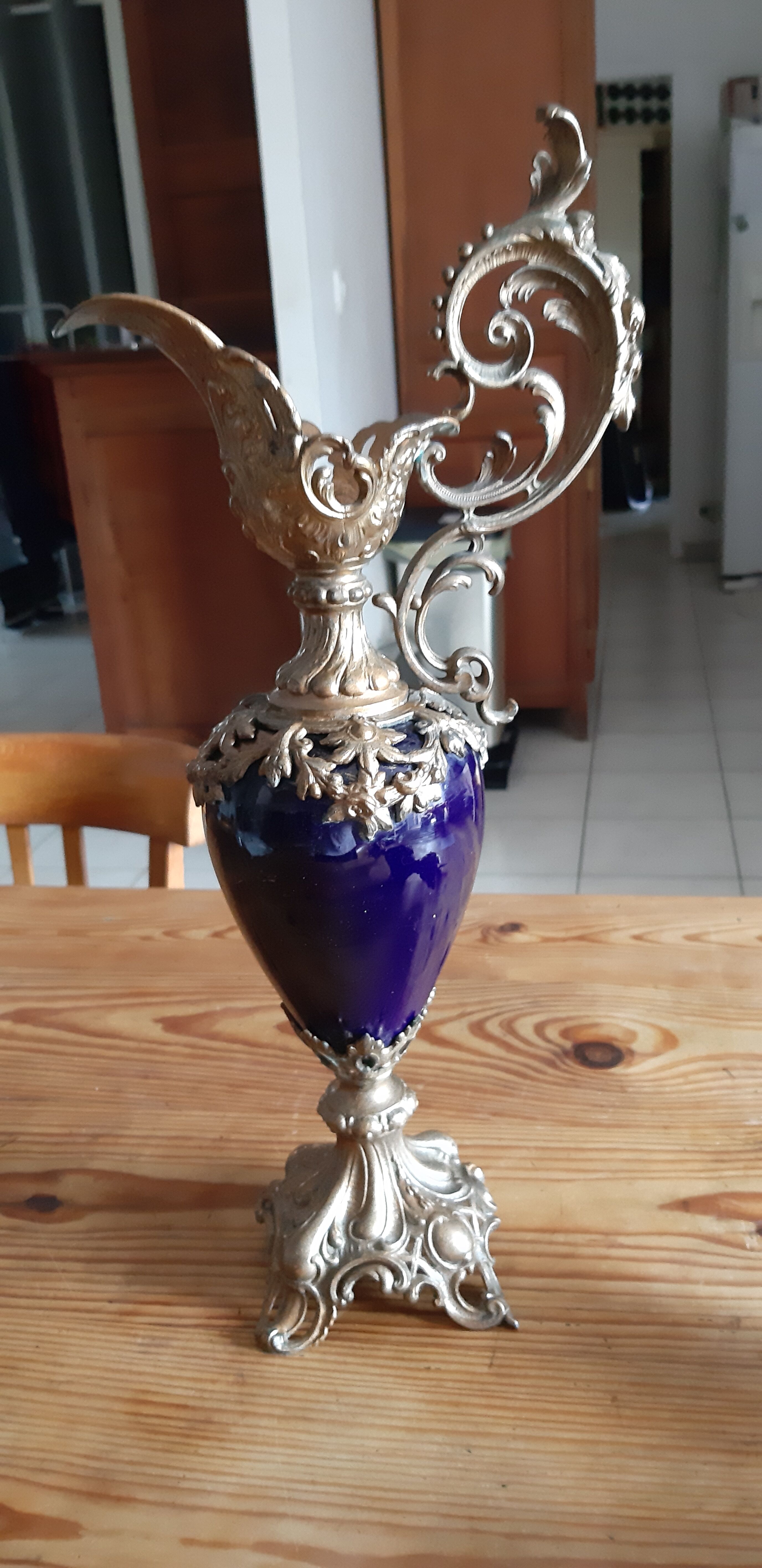 Pair of golden regulated ewers and blue glass