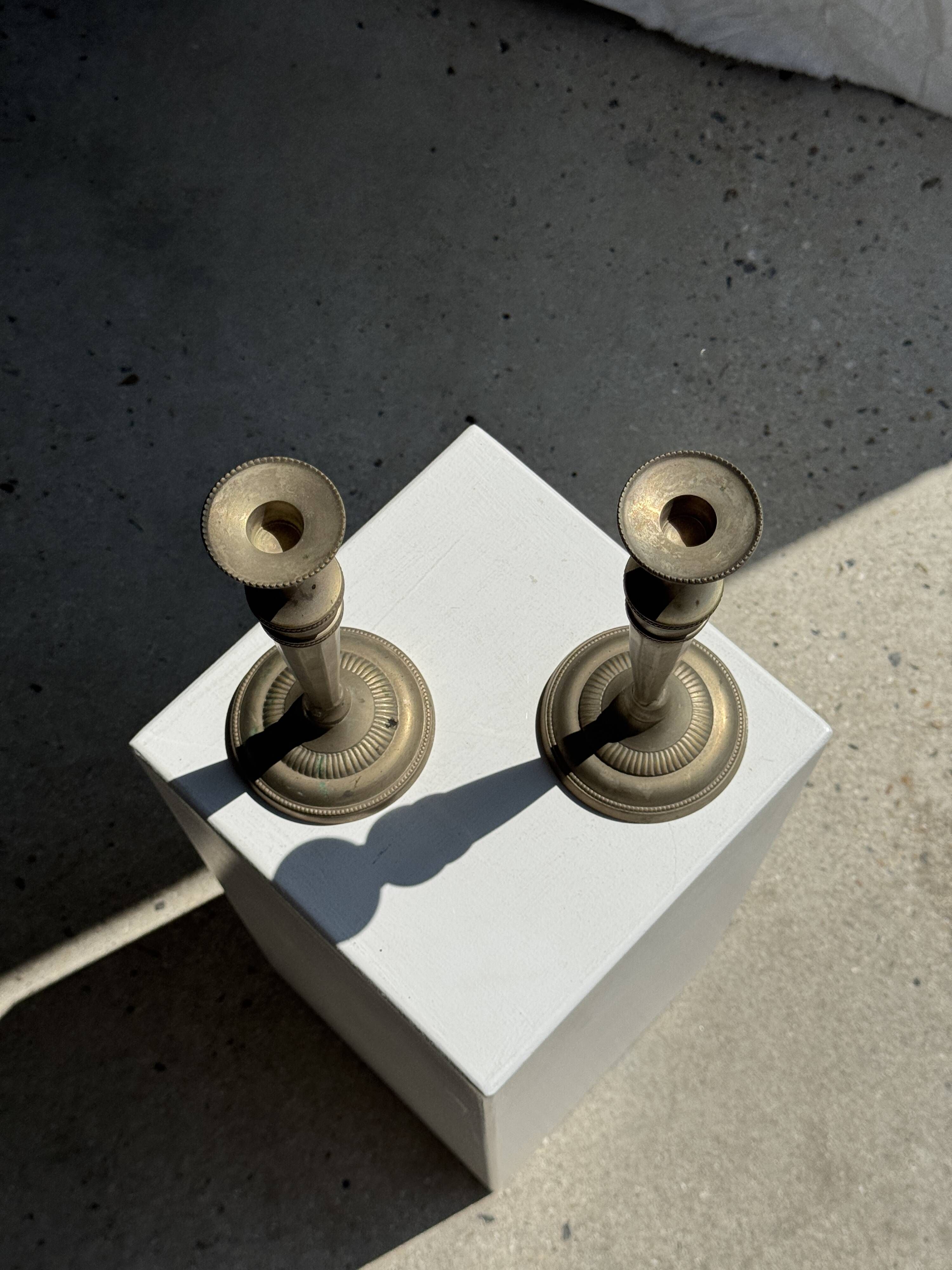 Pair of classic candlesticks in patinated gold metal H25
