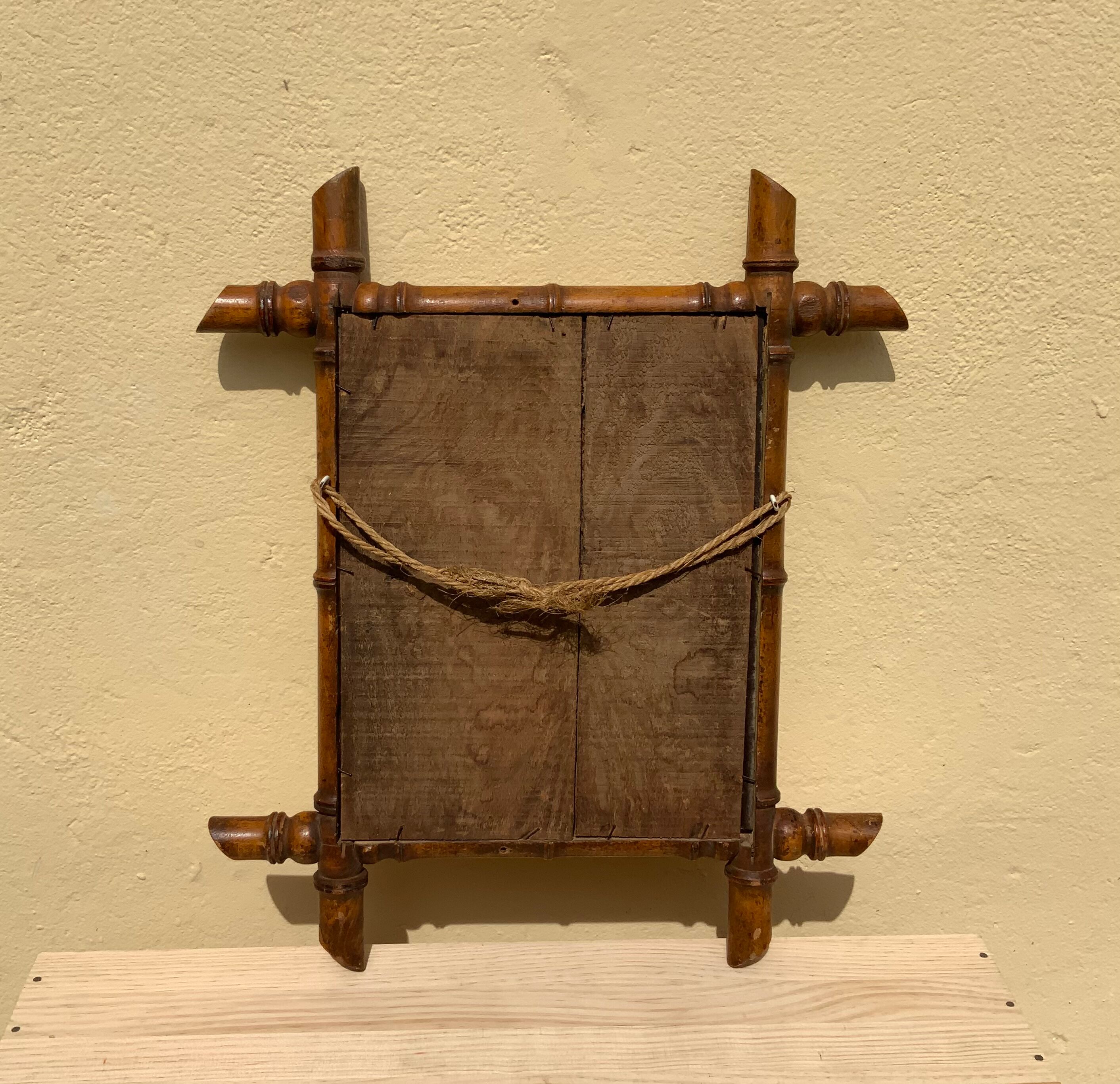 Vintage bamboo mirror in light wood bohemian decoration