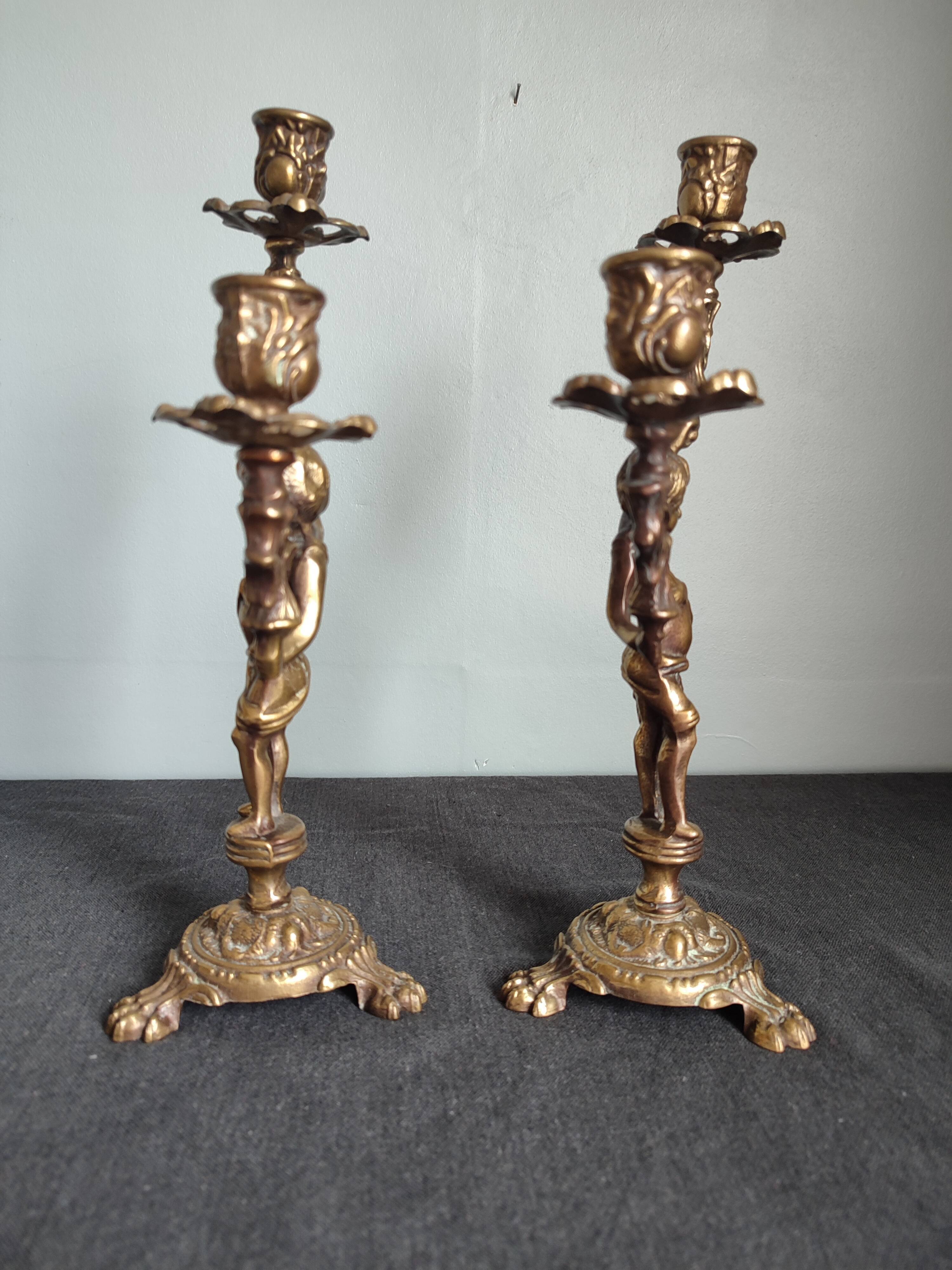 Pair of antique candlesticks in cherub bronze