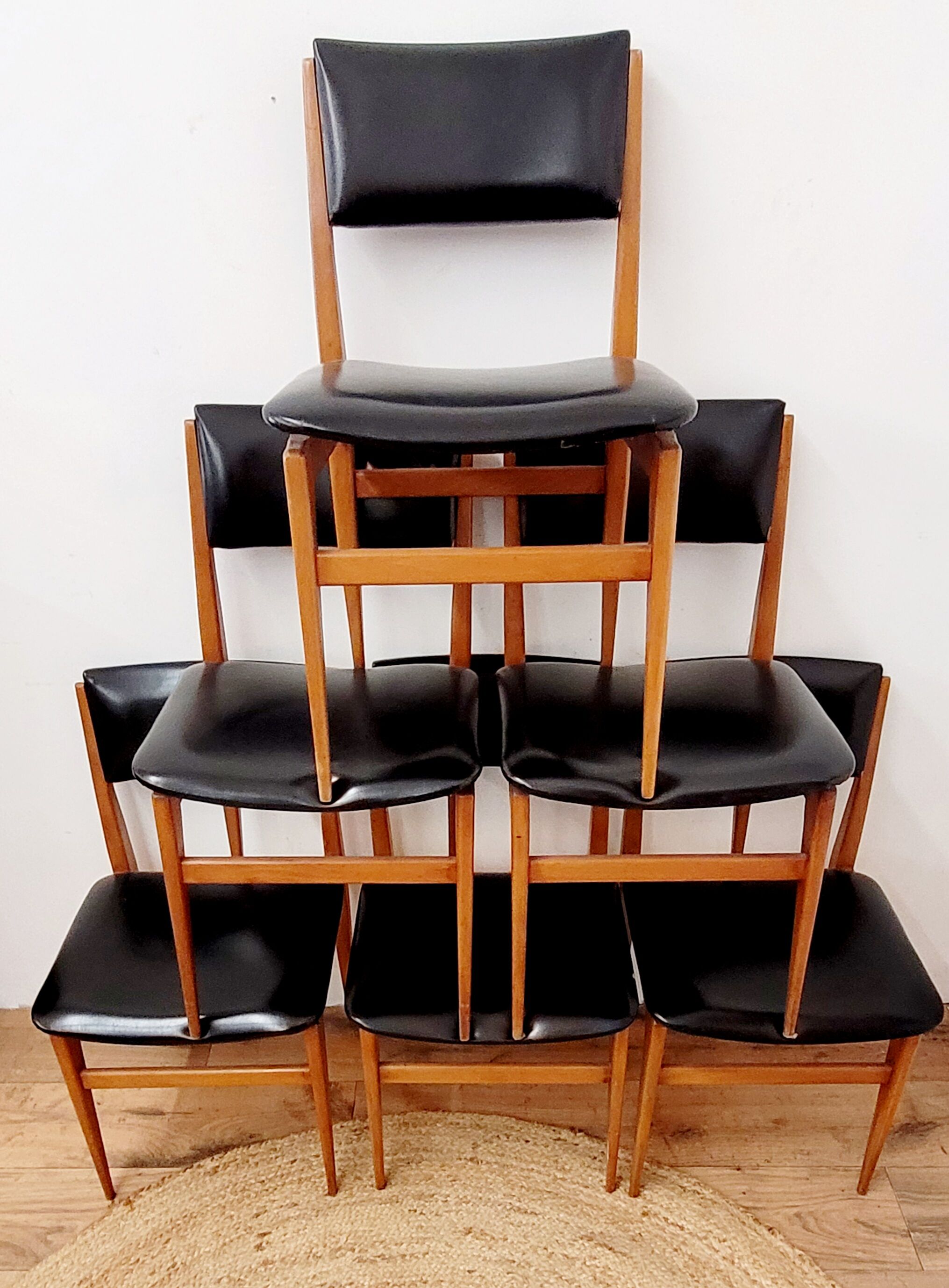 Six vintage wooden chairs and black Skaï