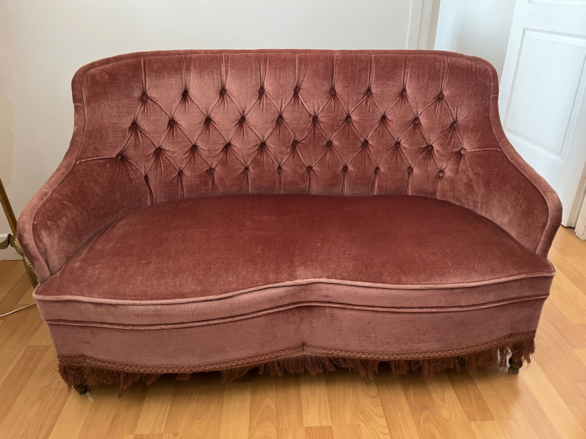 Pink velvet tufted sofa