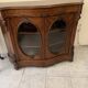 Curved mahogany display cabinet from the Napoleon III period. It has two doors and two shelves.