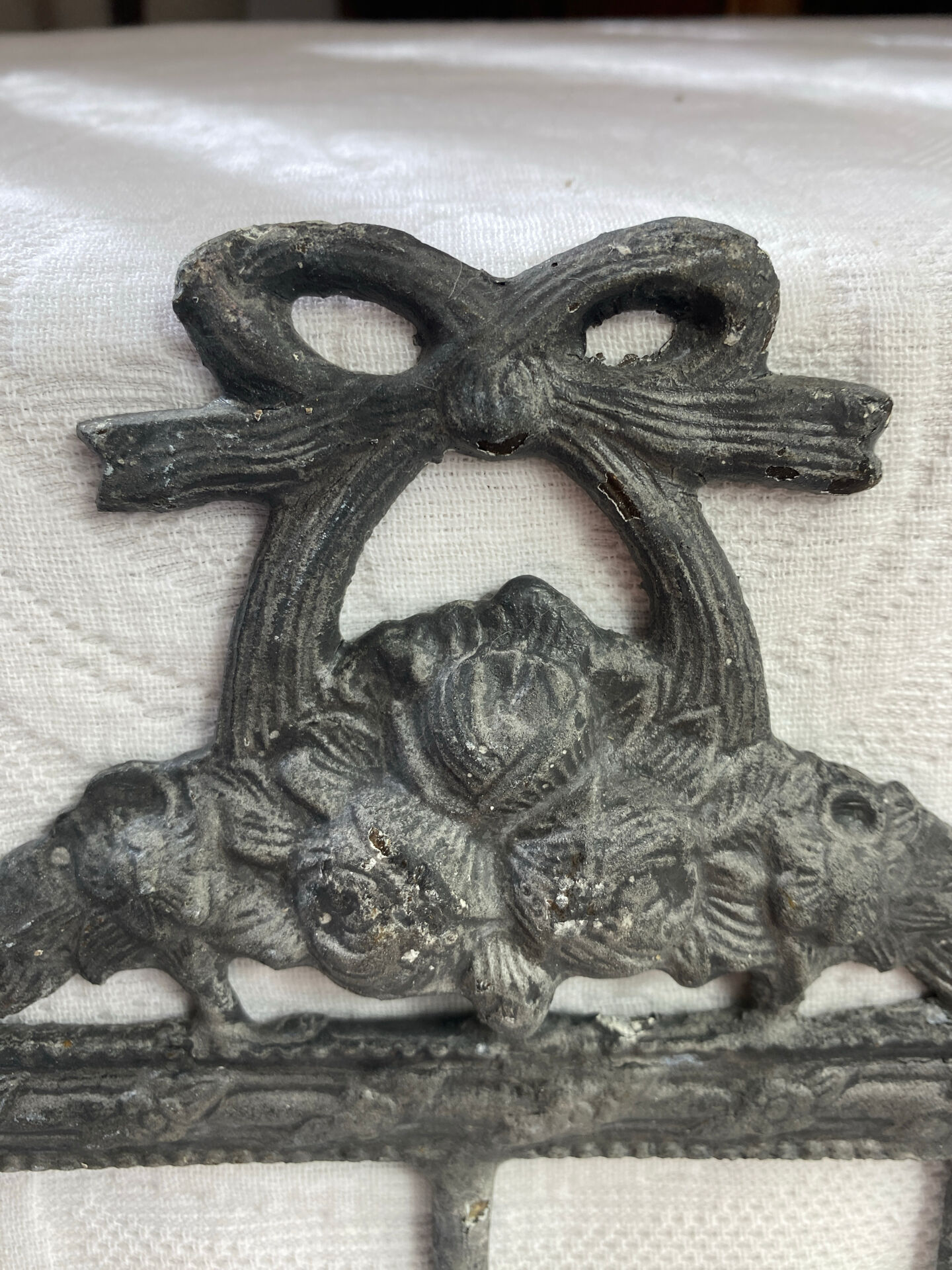 Patinated metal wall bracket and porcelain