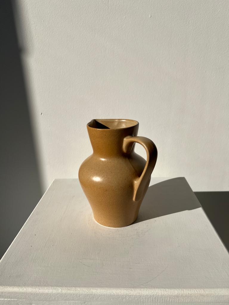 Small pitcher in light beige sandstone