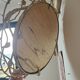 Round mirror in gilded wrought iron and leaves
