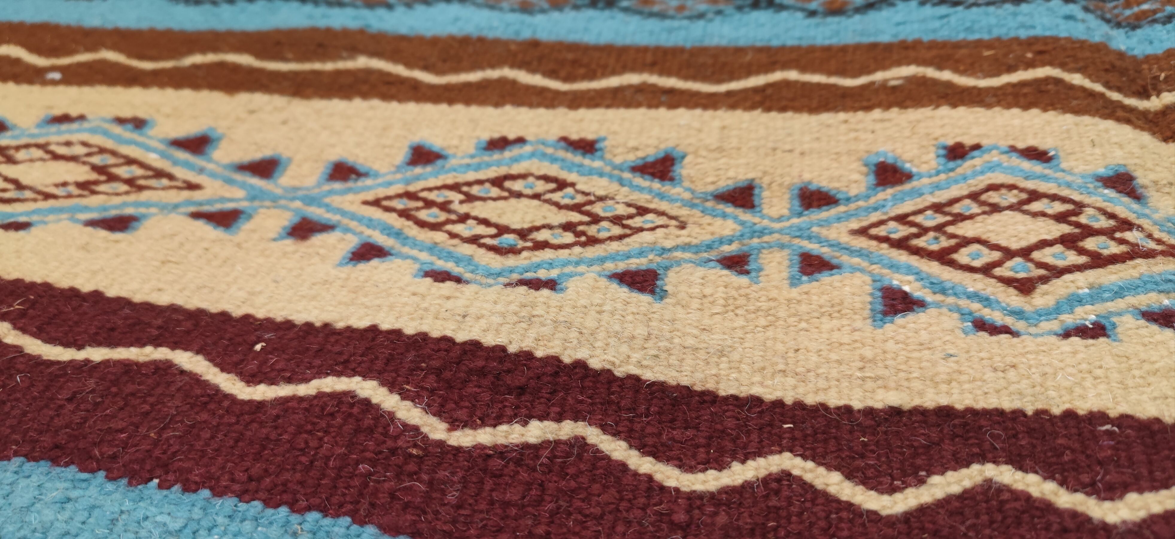 Multicolored hand-woven Berber rugs in natural wool