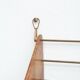 Wall-mounted walnut bookshelf by Carl Auböck, 1950s