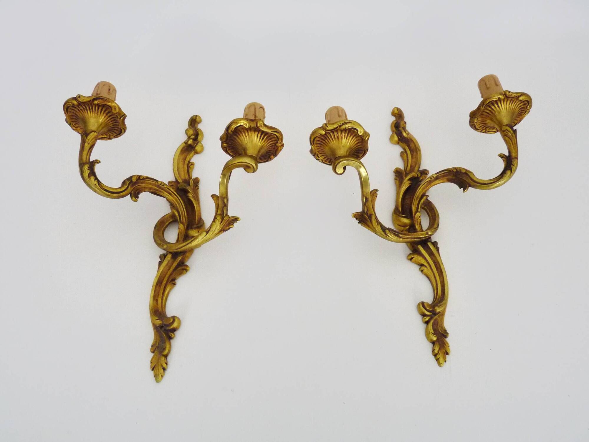Antique pair of double-light bronze wall sconces with acanthus leaves. 1950s