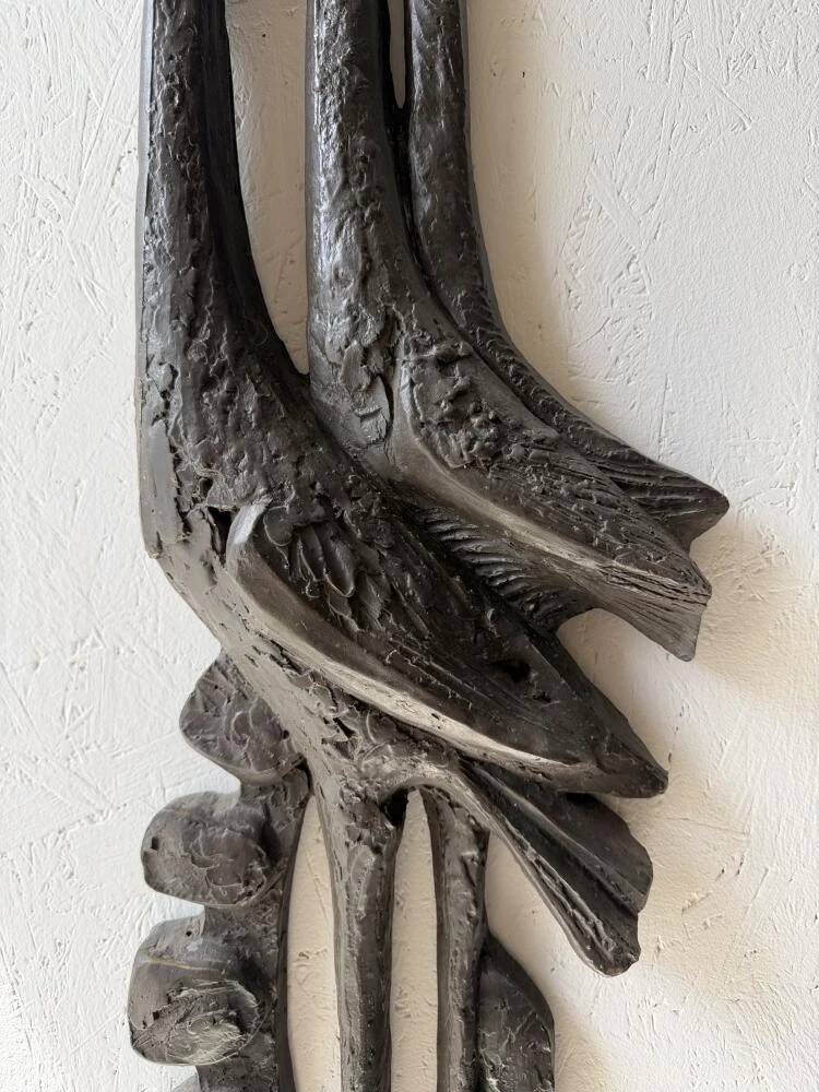 Brutalist wall sculpture with birds Ars Munda