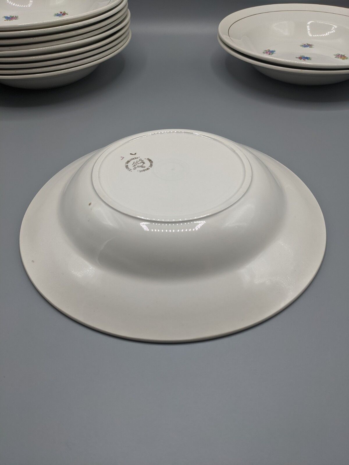 12 hollow porcelain plates, floral decoration and golden ledé - ∅: 23cm