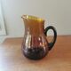 Vintage round pitcher amber glass