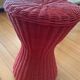 Vintage hourglass stool in red wicker or woven rattan.