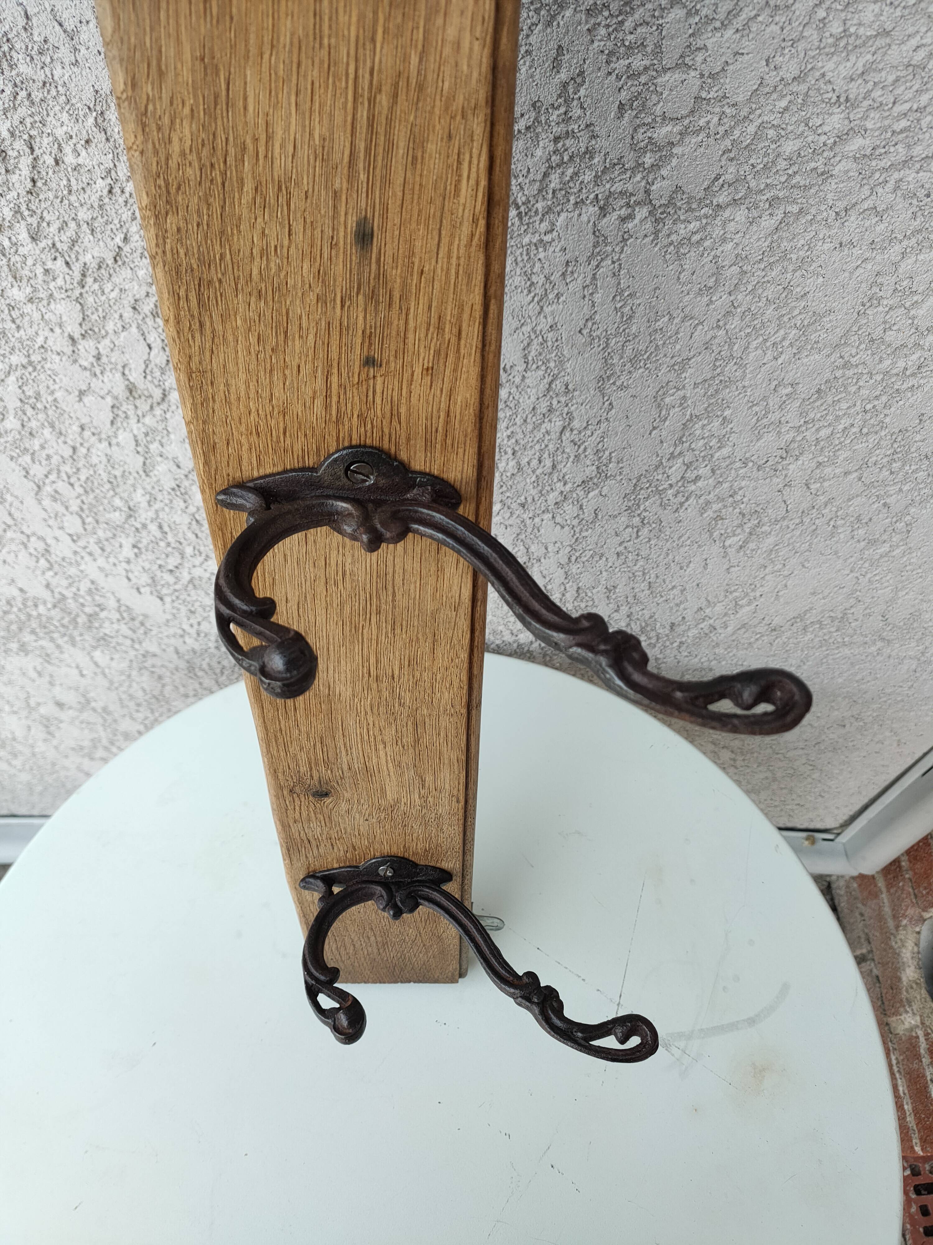 antique coat rack with 3 cast iron hooks