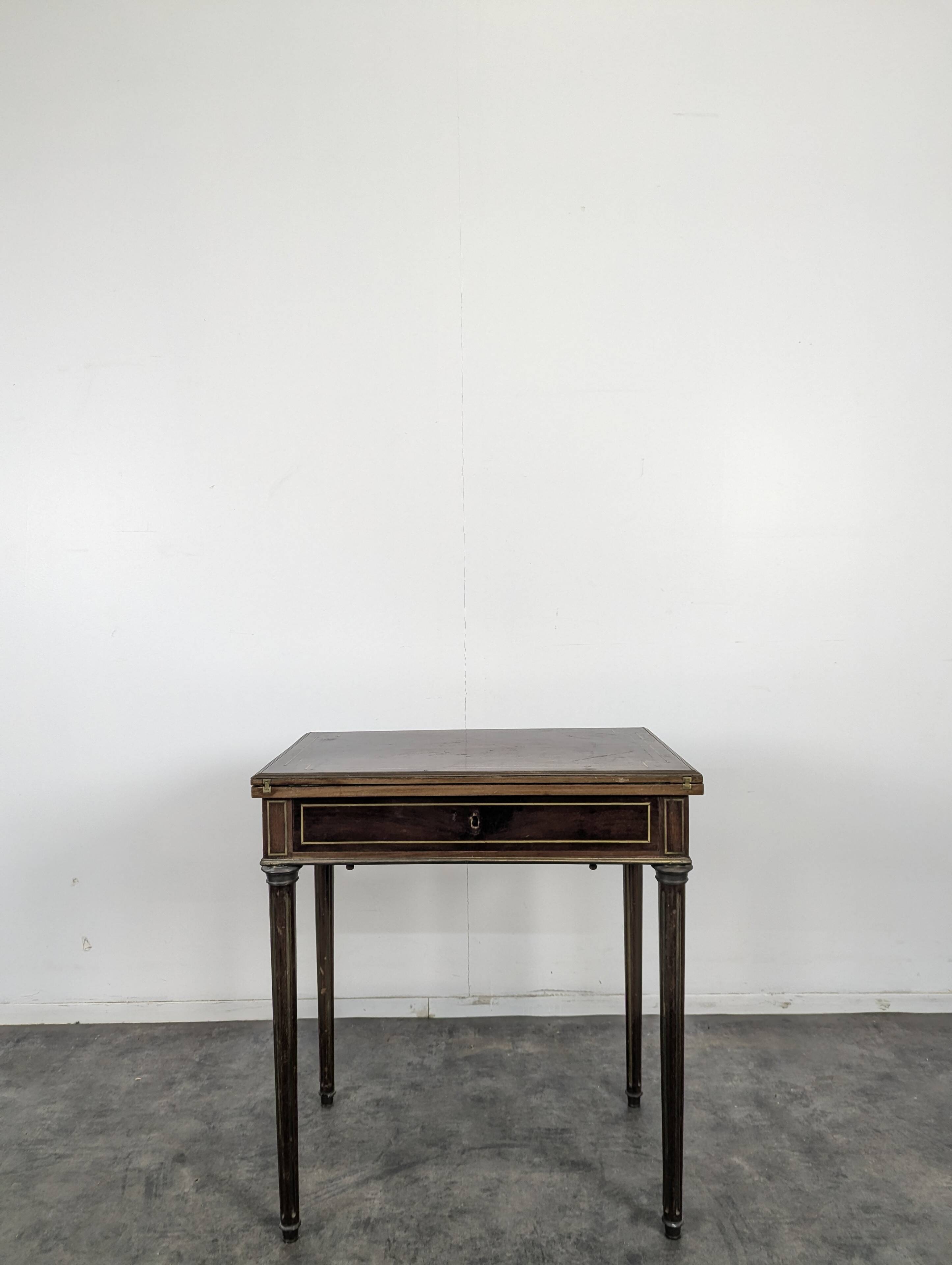 Louis XVI style mahogany game table, dressing table, and secretary.