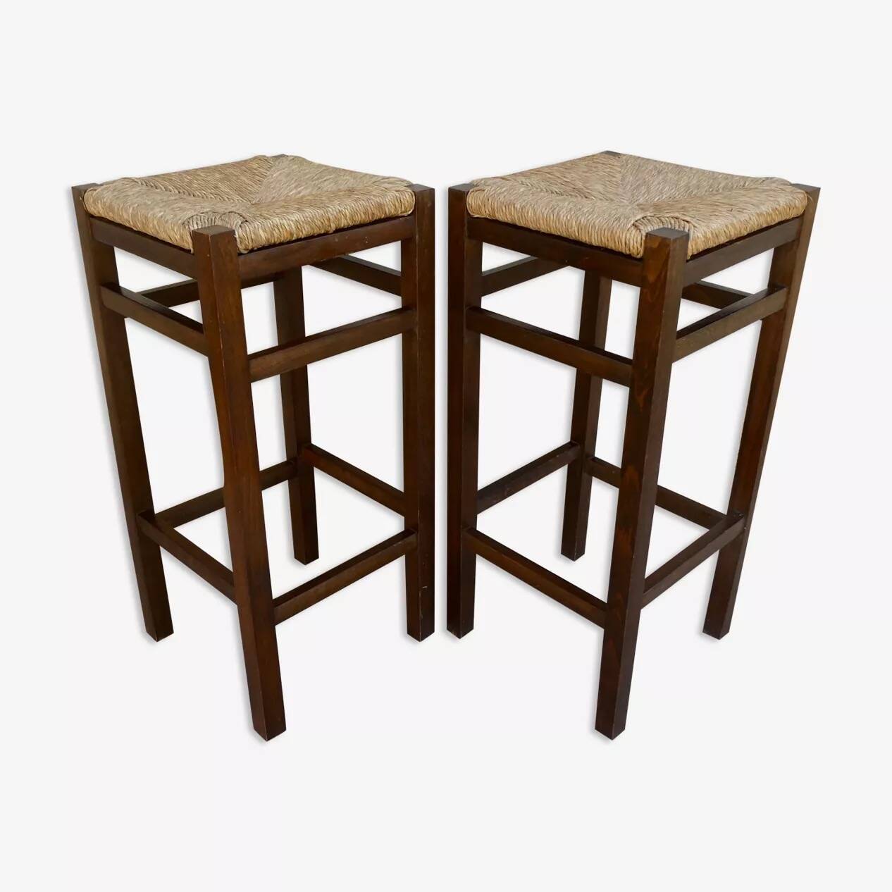 pair of bar stools, made of wood with a straw seat