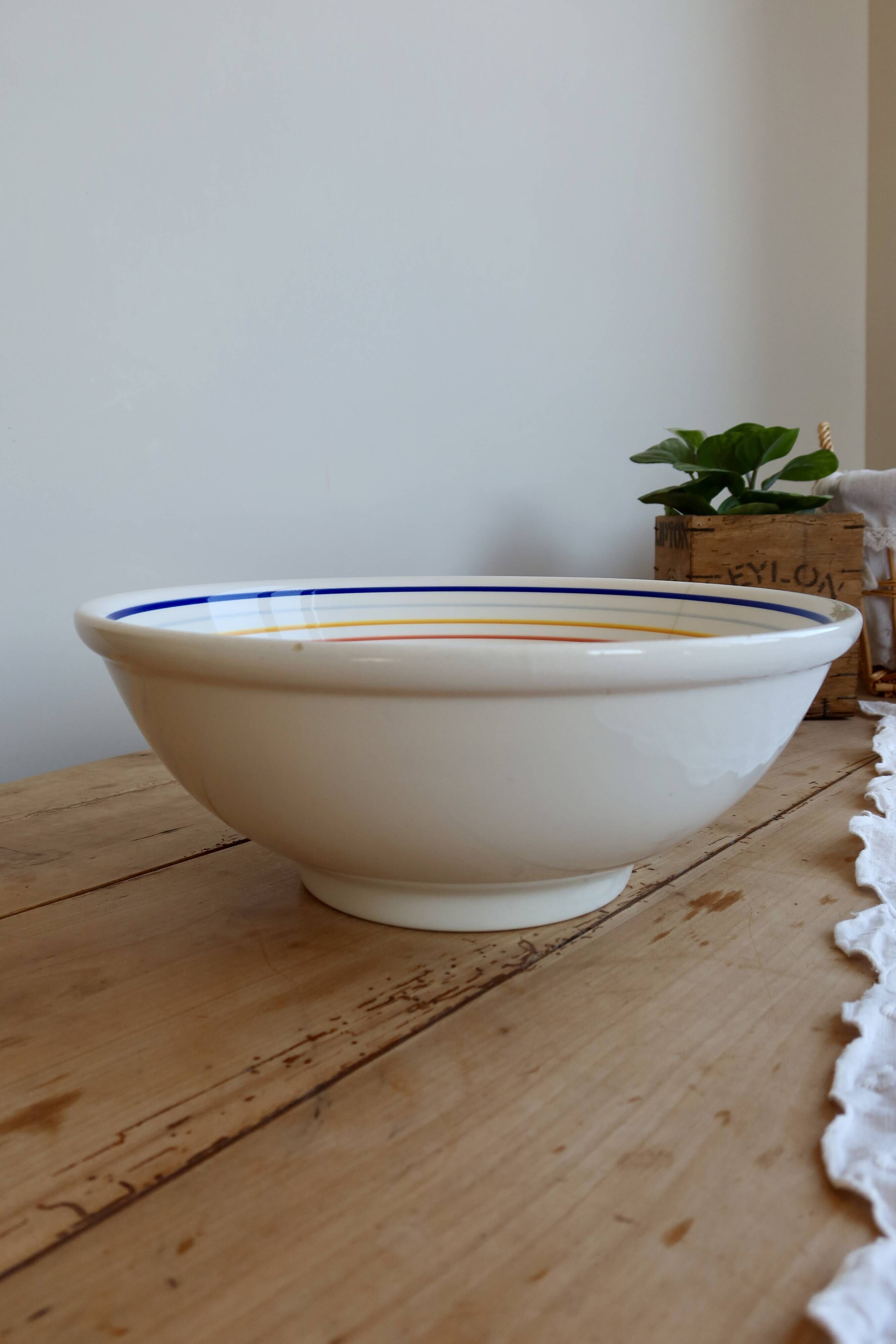 Vintage porcelain salad bowl with multicoloured borders.