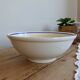 Vintage porcelain salad bowl with multicoloured borders.
