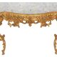 Console with a gilded wooden mirror.