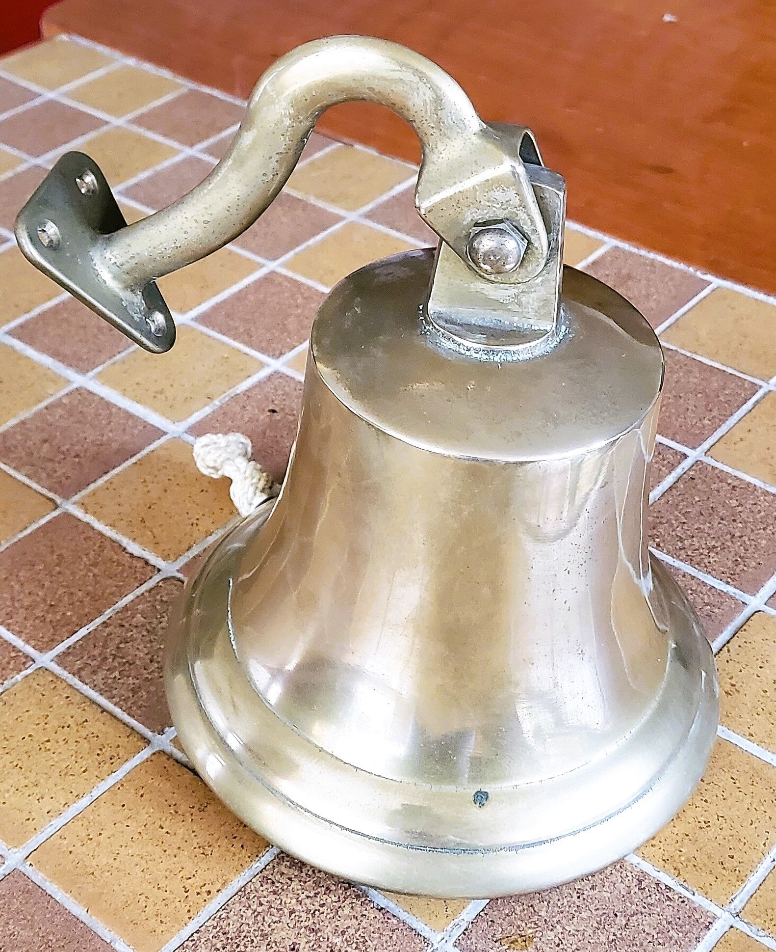 Polished brass bell with its stem