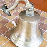 Polished brass bell with its stem