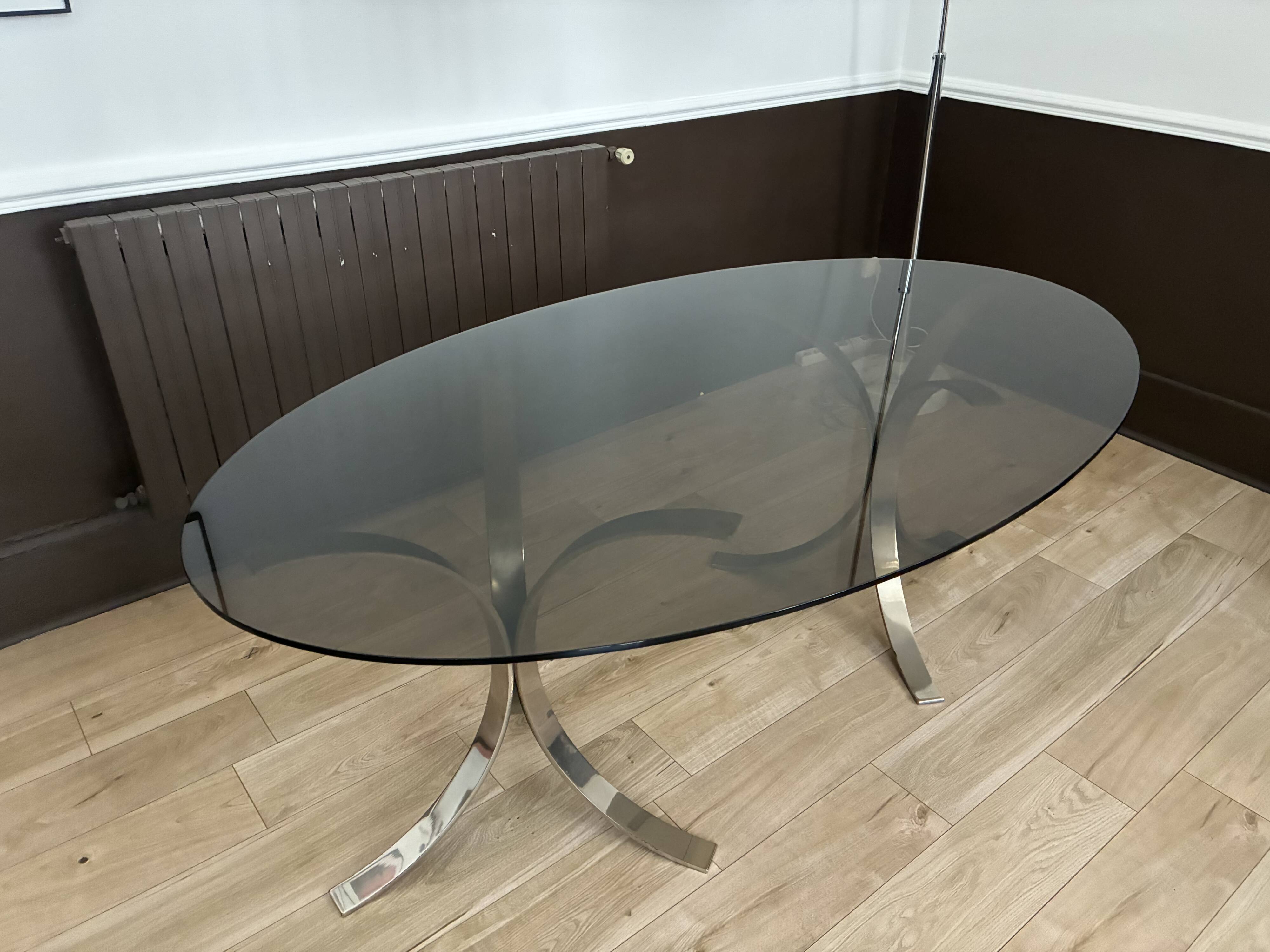 Smoked glass table with a metal base.