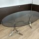 Smoked glass table with a metal base.