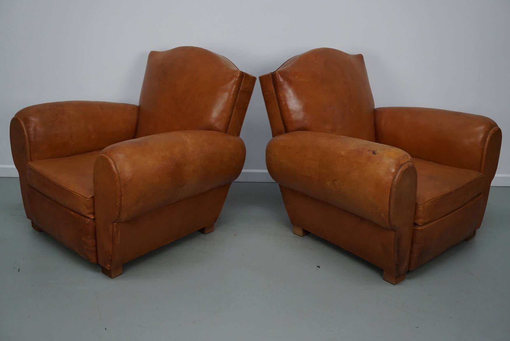 Pair of French club chairs with moustache back in cognac leather, 1950s