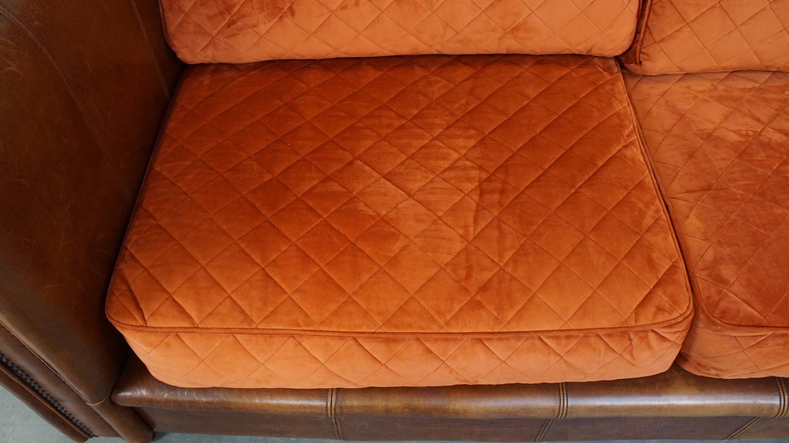 Luxury and comfortable sheepskin 2.5-seater sofa of top quality with orange fabric seat and back cushions