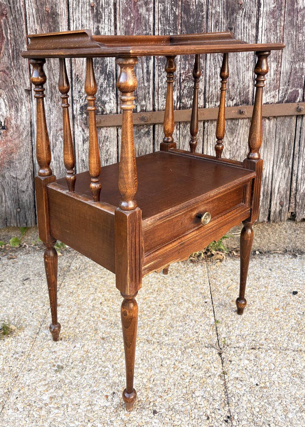 Solid wood bedside table with turned columns, early 20th century.