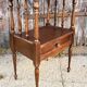 Solid wood bedside table with turned columns, early 20th century.