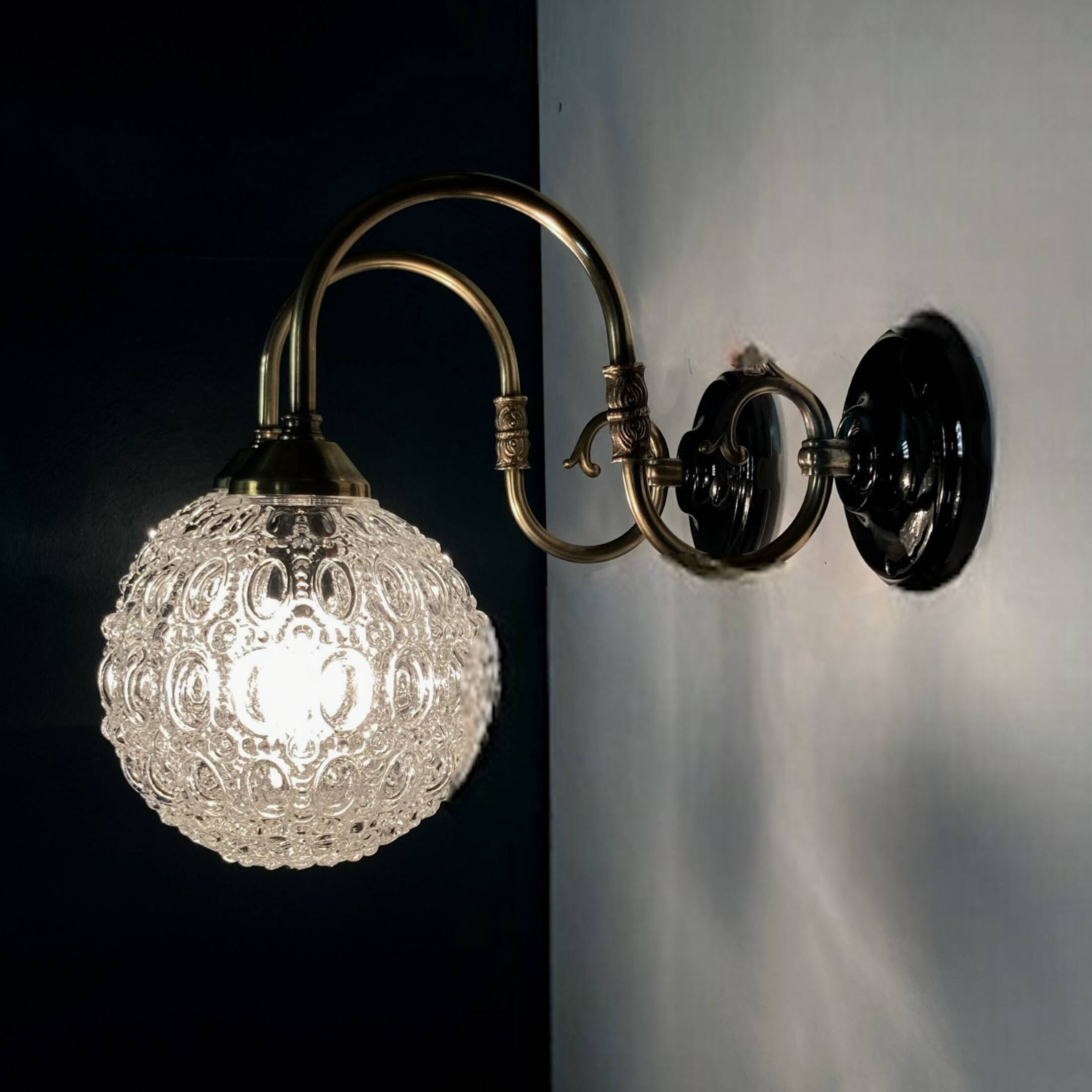 Pair of old swan neck wall lights in brass and transparent glass globe
