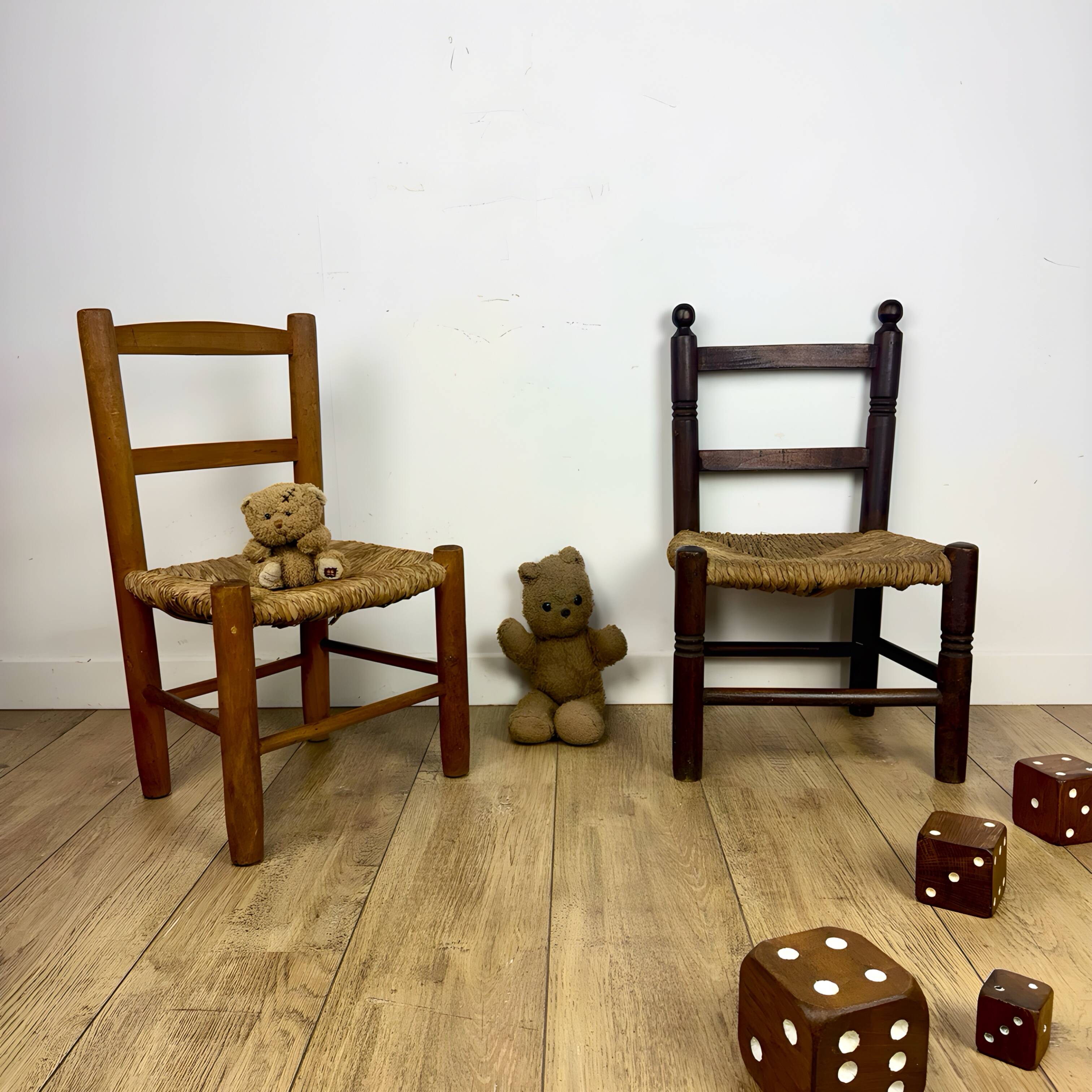 Pair of old wooden and straw children's chairs.