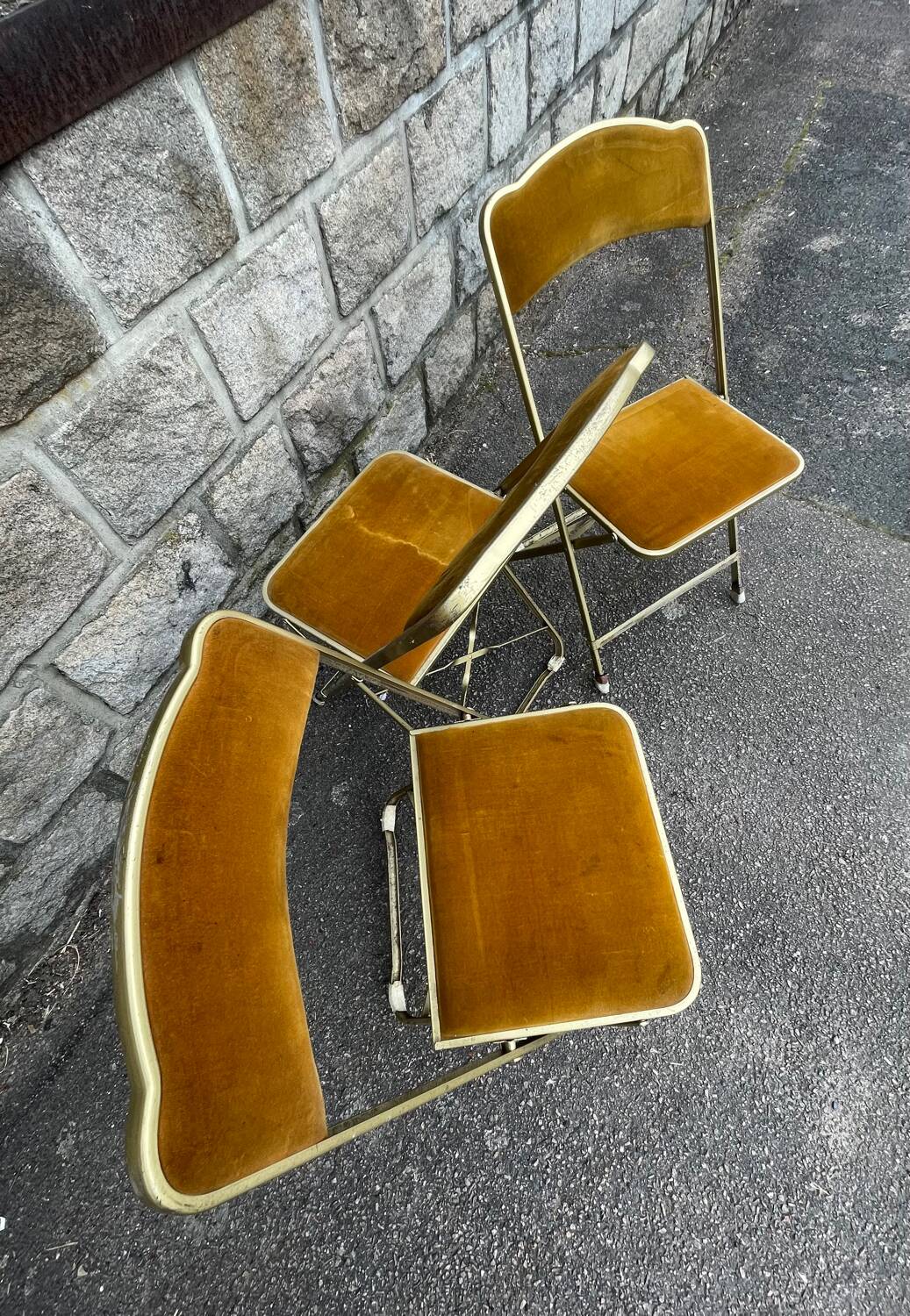 Three folding opera chairs in old gold velvet and brass structure