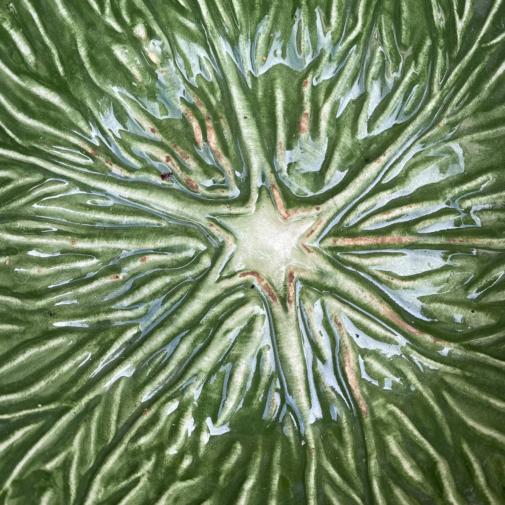Large earthenware salad bowl in the shape of a cabbage leaf.