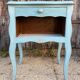 Pair of patinated lagoon blue bedside tables, early 20th century, with curved legs.